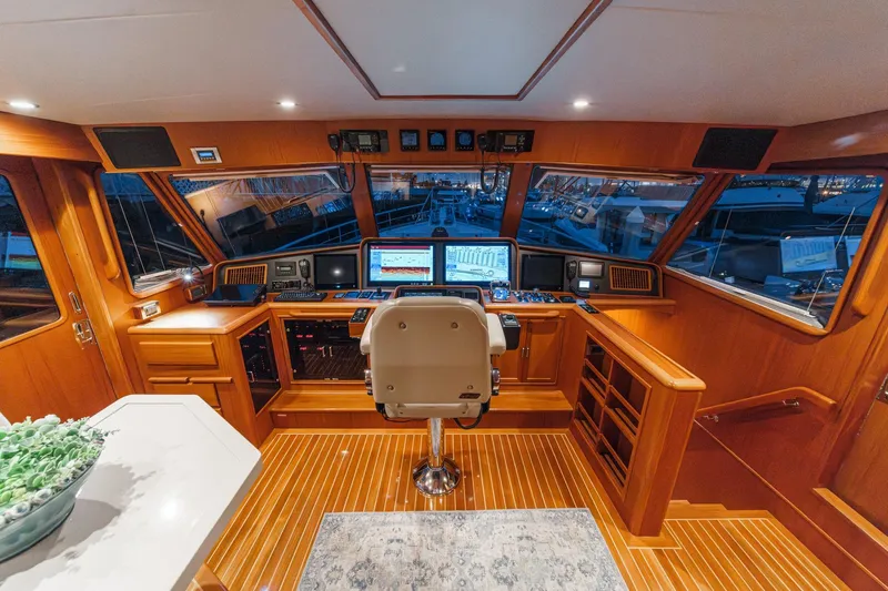 Slide: The Image of Luxurious 2018 Fleming 58 Pilothouse interior with advanced navigation systems and elegant wood finish. - 39