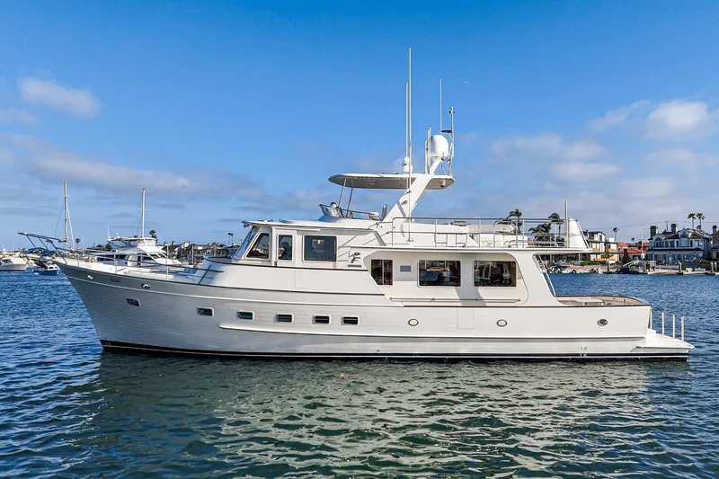 Slide: The Image of 2018 Fleming 58 Pilothouse yacht on calm water under blue sky. - 4