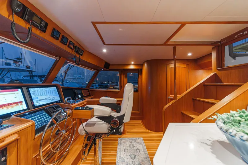 Slide: The Image of Luxurious 2018 Fleming 58 Pilothouse interior with advanced navigation systems and elegant wood finish. - 40
