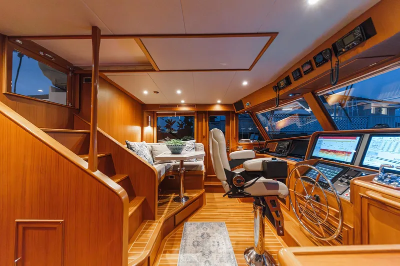 Slide: The Image of Luxurious 2018 Fleming 58 Pilothouse interior with wood finish and advanced navigation equipment. - 43