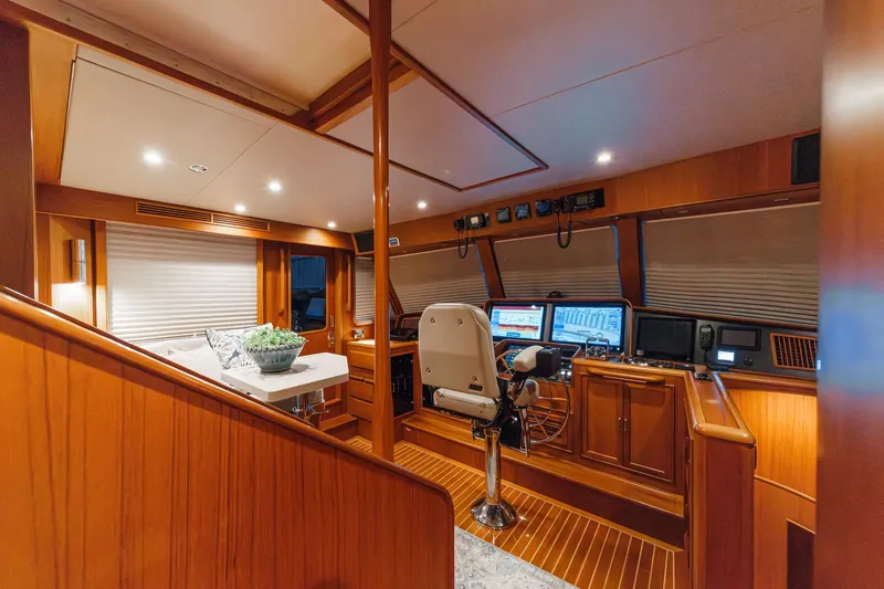 Slide: The Image of Luxurious 2018 Fleming 58 Pilothouse interior with modern navigation equipment and elegant wood finish. - 46