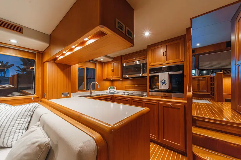 Slide: The Image of Luxurious 2018 Fleming 58 Pilothouse yacht interior with modern kitchen and wooden cabinetry. - 50