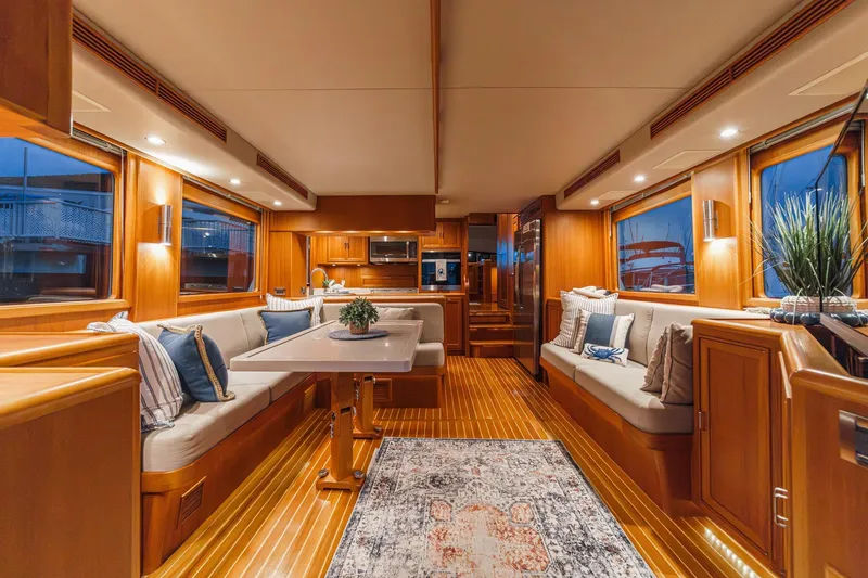Slide: The Image of Luxurious 2018 Fleming 58 Pilothouse yacht interior with elegant wood finishes and plush seating. - 58
