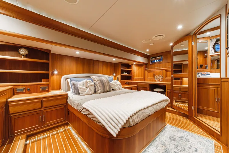 Slide: The Image of Luxurious 2018 Fleming 58 Pilothouse yacht bedroom with elegant wood finish and cozy bedding. - 61