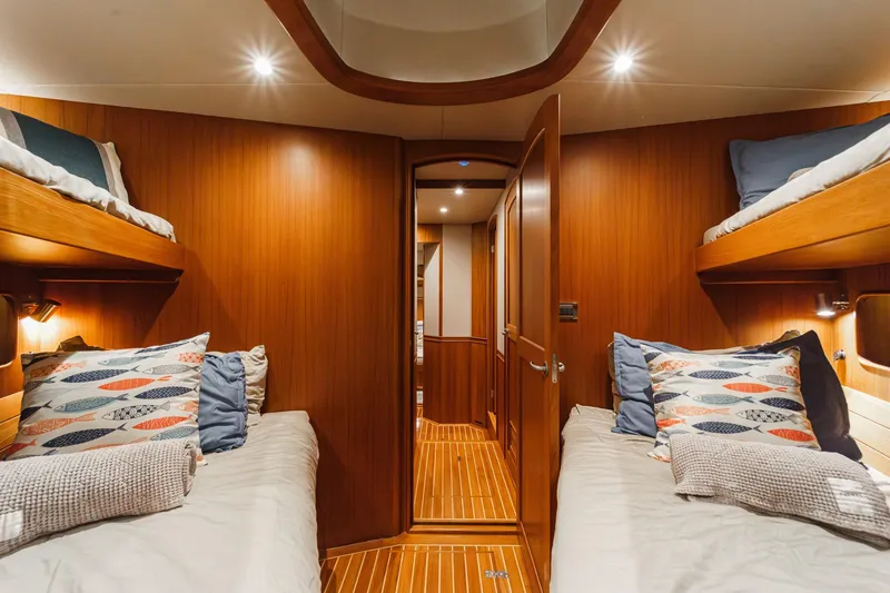 Slide: The Image of Luxurious cabin interior of 2018 Fleming 58 Pilothouse yacht with wooden finish and cozy bedding. - 64