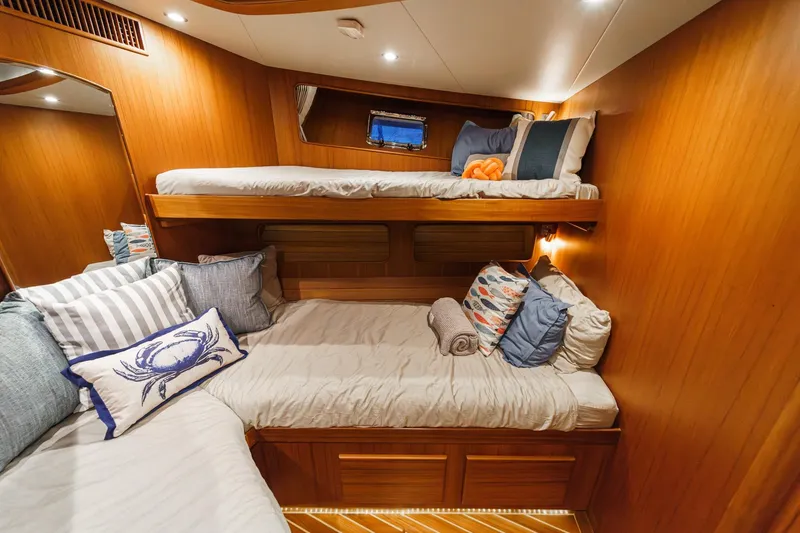 Slide: The Image of Cozy cabin interior of 2018 Fleming 58 Pilothouse with wooden finish and plush bedding. - 65