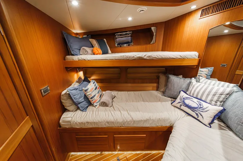 Slide: The Image of Luxurious 2018 Fleming 58 Pilothouse cabin with cozy bunk beds and nautical-themed decor. - 66
