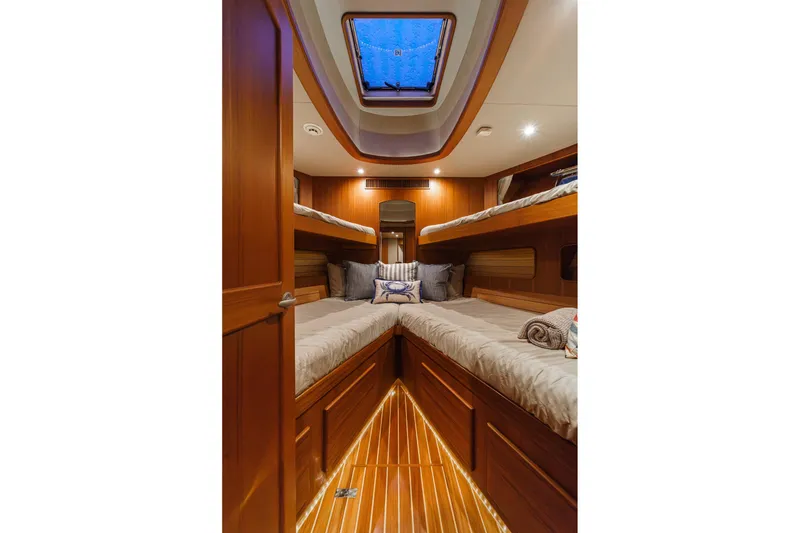 Slide: The Image of Luxurious cabin interior of 2018 Fleming 58 Pilothouse yacht with wooden finishes and cozy bedding. - 67