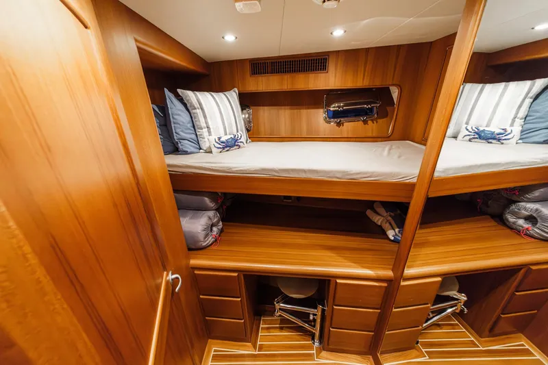 Slide: The Image of Luxurious wooden cabin interior of 2018 Fleming 58 Pilothouse yacht with bunk beds. - 69
