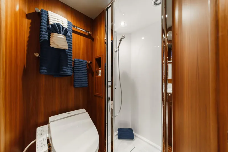 Slide: The Image of Luxurious bathroom in 2018 Fleming 58 Pilothouse yacht with wood paneling and modern fixtures. - 71