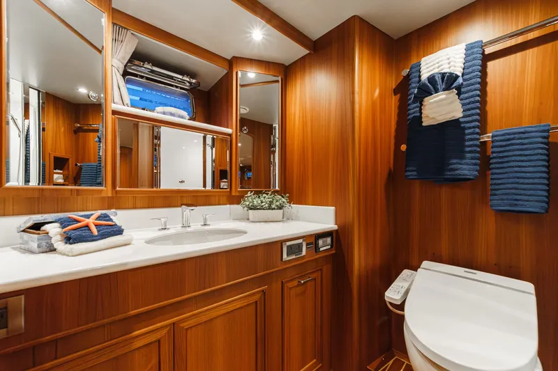 Slide: The Image of Luxurious 2018 Fleming 58 Pilothouse yacht bathroom with wood paneling and modern fixtures. - 72