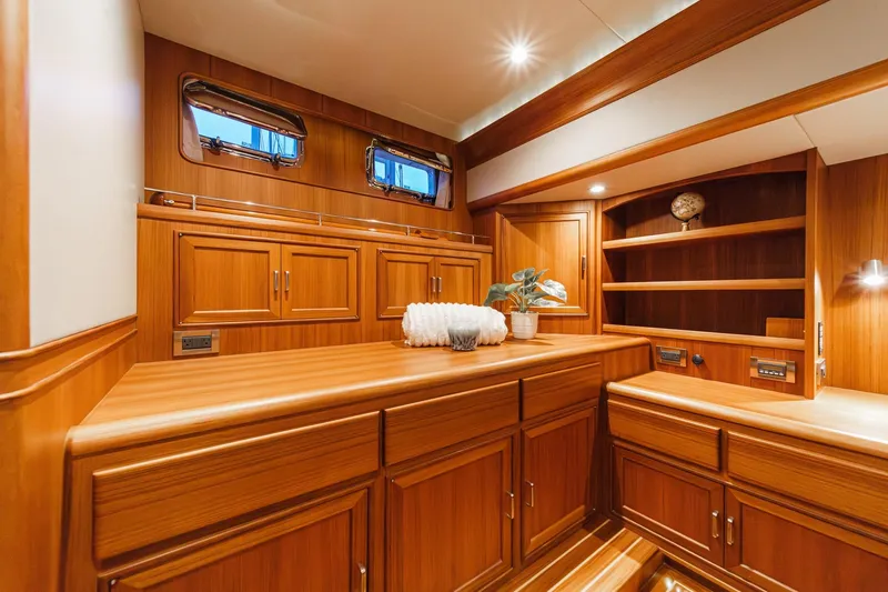 Slide: The Image of Luxurious wood interior of 2018 Fleming 58 Pilothouse yacht with cabinets and decor. - 74