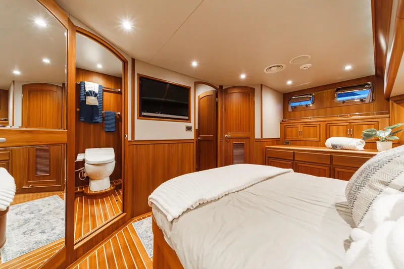 Slide: The Image of Luxurious 2018 Fleming 58 Pilothouse yacht interior with wood finish and modern amenities. - 76
