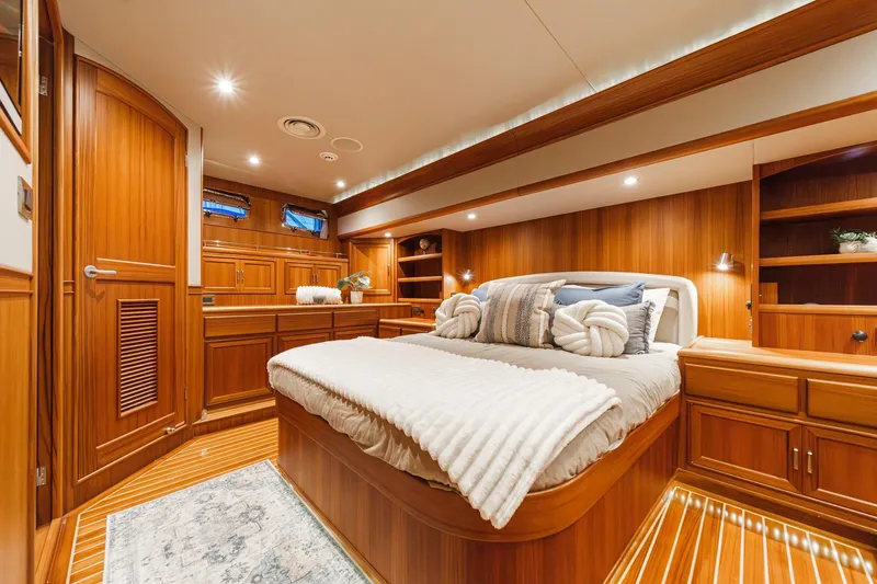 Slide: The Image of Luxurious 2018 Fleming 58 Pilothouse yacht bedroom with elegant wood finish and cozy bedding. - 77