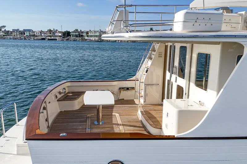 Slide: The Image of 2018 Fleming 58 Pilothouse yacht with spacious deck overlooking serene waterfront. - 81