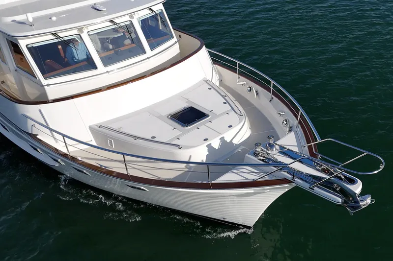 Slide: The Image of 2018 Fleming 58 Pilothouse yacht cruising on calm waters. - 9