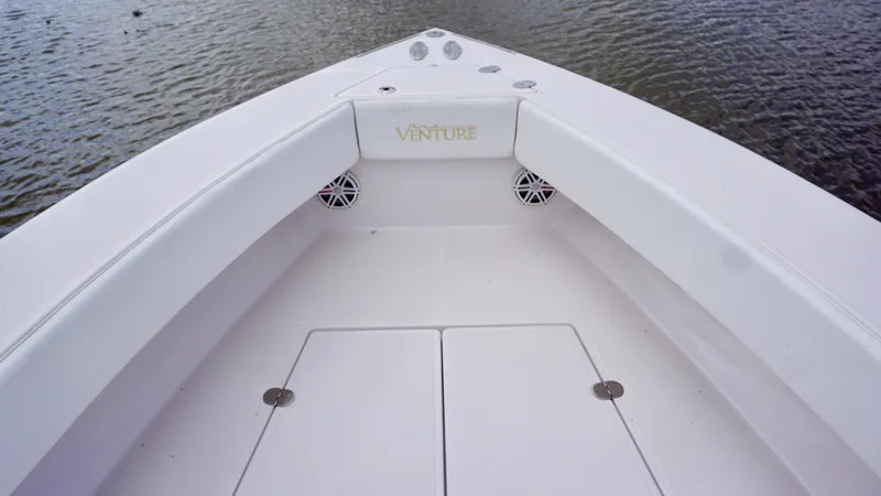 Slide: The Image of 2009 Venture 39 Open boat bow with seating and storage, on calm water. - 10