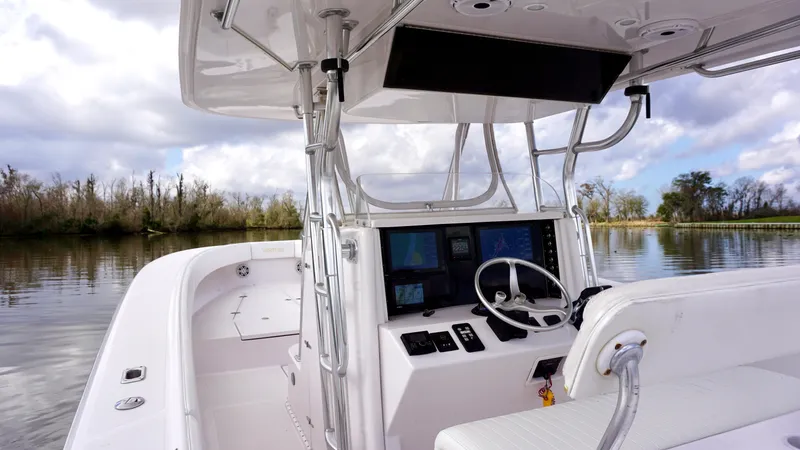 Slide: The Image of 2009 Venture 39 Open boat interior with steering console on a calm river. - 19