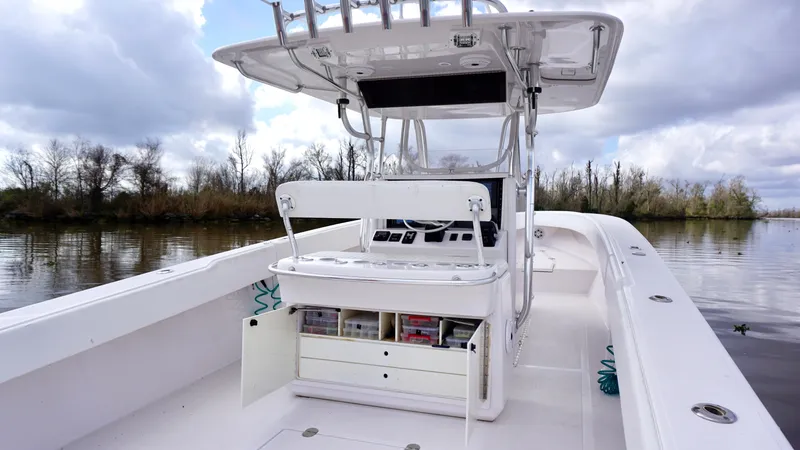 Slide: The Image of 2009 Venture 39 Open boat with center console and storage, on a calm river. - 20