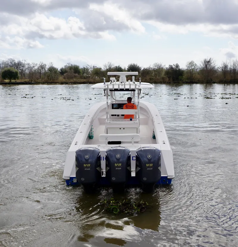 Slide: The Image of 2009 Venture 39 Open boat with triple engines on a calm river. - 8