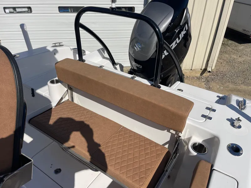 Slide: The Image of 2024 Sea Pro 242 Center Console boat with brown seating and Suzuki outboard motor. - 12