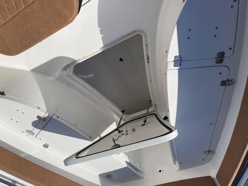 Slide: The Image of 2024 Sea Pro 242 Center Console boat storage compartment with open hatch. - 13