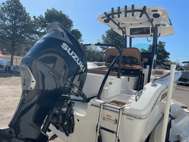 Slide: The Image of 2024 Sea Pro 242 Center Console boat with Suzuki outboard motor, docked outdoors. - 4