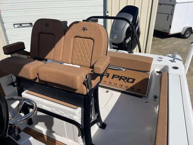Slide: The Image of 2024 Sea Pro 242 Center Console boat with tan seating and modern helm design. - 8