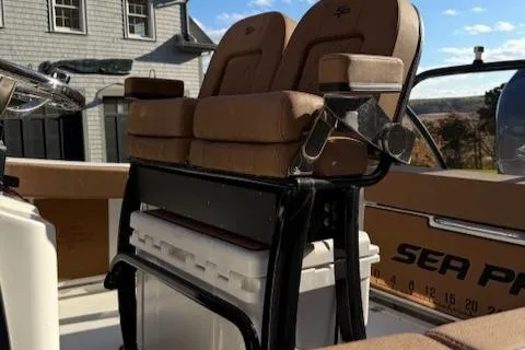 Slide: The Image of 2024 Sea Pro 242 Center Console boat with tan seating and storage compartment. - 9