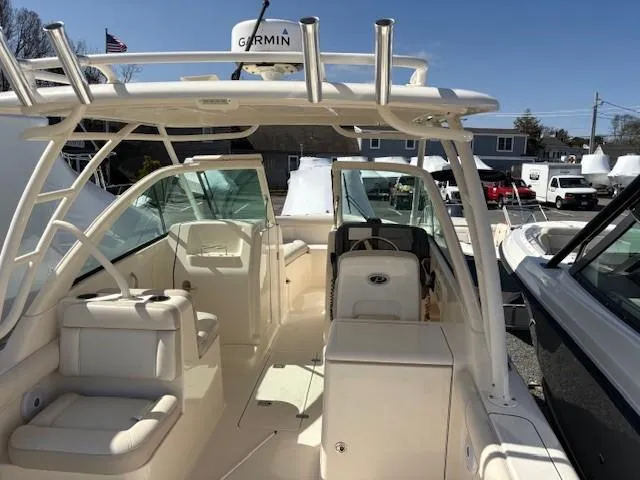 Slide: The Image of 2013 Pursuit 265 Dual Console boat with Garmin equipment, docked in a marina. - 15