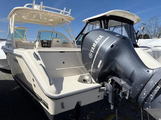 Slide: The Image of 2013 Pursuit 265 Dual Console boat with Yamaha outboard engine, docked outdoors. - 8