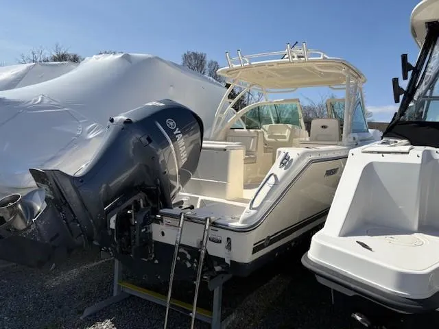 Slide: The Image of 2013 Pursuit 265 Dual Console boat with Yamaha outboard motor, docked outdoors. - 9