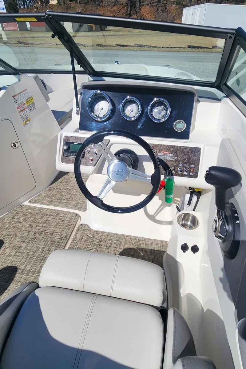 Slide: The Image of 2021 Sea Ray SPX 190 boat dashboard with steering wheel and gauges. - 10