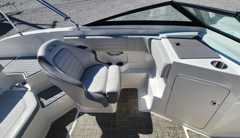 Slide: The Image of 2021 Sea Ray SPX 190 boat interior with gray seating and modern dashboard. - 11