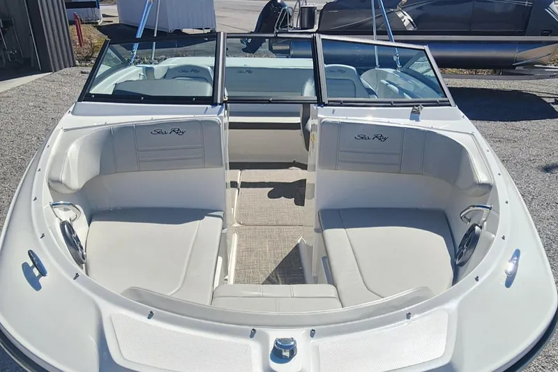 Slide: The Image of 2021 Sea Ray SPX 190 boat interior with white seating and open bow design. - 2