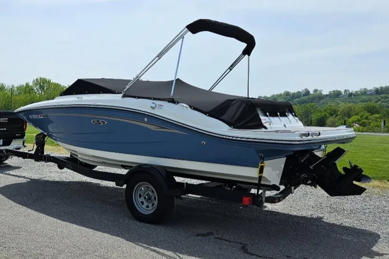 Slide: The Image of 2021 Sea Ray SPX 190 boat on trailer, blue and white design, parked outdoors. - 4