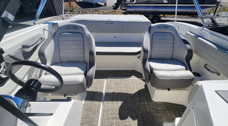 Slide: The Image of 2021 Sea Ray SPX 190 boat interior with two cushioned seats and steering wheel. - 8