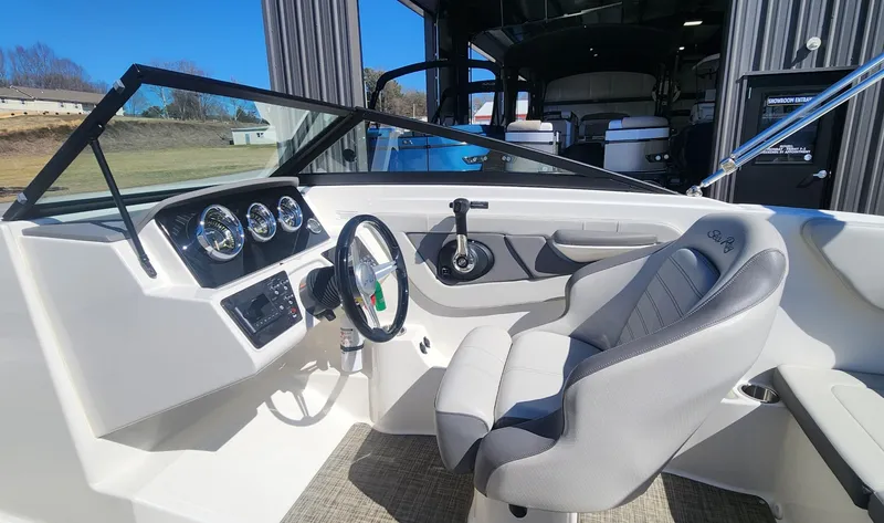 Slide: The Image of 2021 Sea Ray SPX 190 boat interior with steering wheel and dashboard gauges. - 9