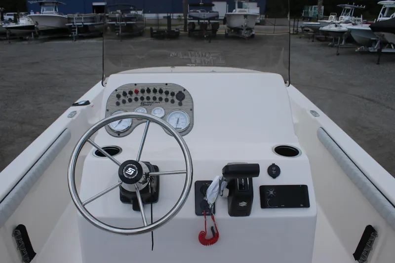 Slide: The Image of 2025 Carolina Skiff 23 LS boat dashboard with steering wheel and control panel. - 4