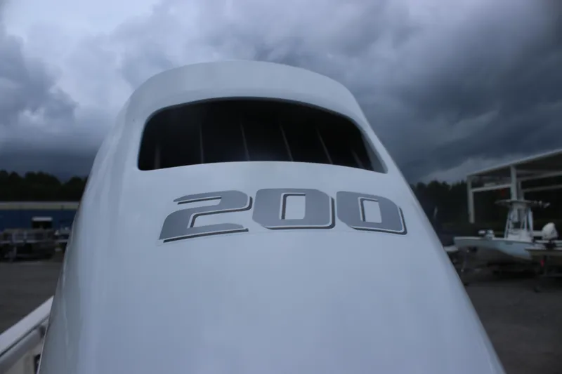 Slide: The Image of 2025 Carolina Skiff 23 LS boat engine with "200" marking under cloudy sky. - 6