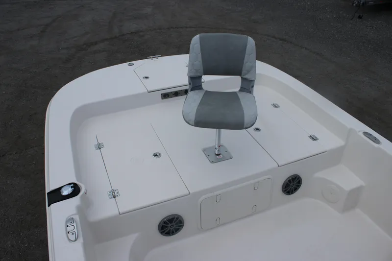 Slide: The Image of 2025 Carolina Skiff 23 LS boat deck with swivel chair and storage compartments. - 7