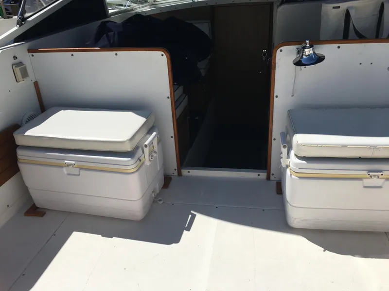 Slide: The Image of 1976 Bertram 26 Moppie boat interior with seating and storage compartments. - 10