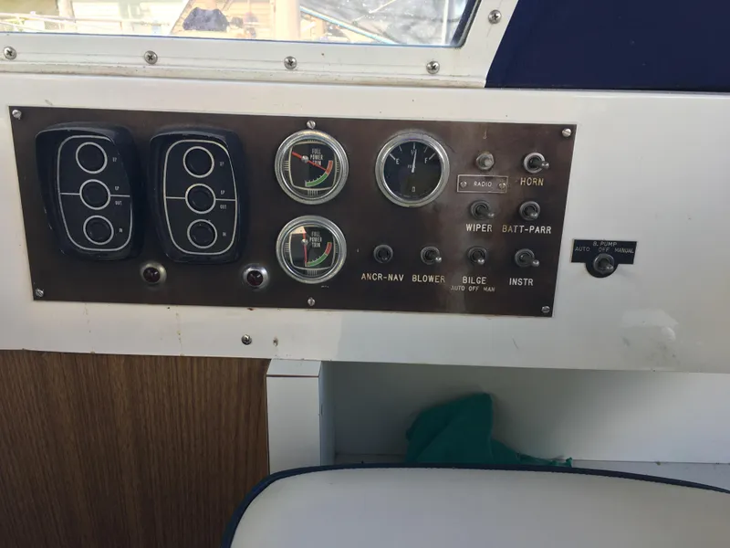 Slide: The Image of Control panel of a 1976 Bertram 26 Moppie boat with gauges and switches. - 12