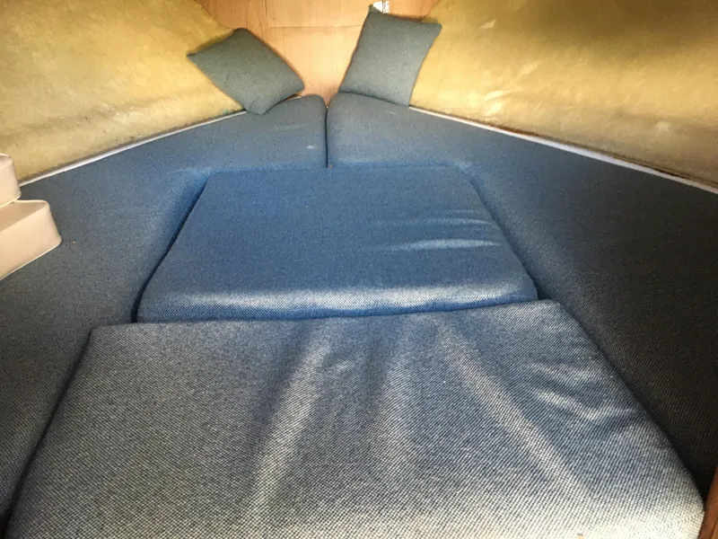 Slide: The Image of Interior cabin of a 1976 Bertram 26 Moppie boat with blue cushions. - 14
