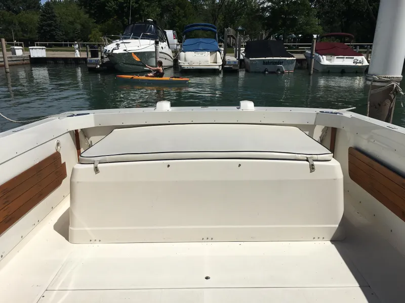 Slide: The Image of 1976 Bertram 26 Moppie boat interior at a marina with docked boats. - 7