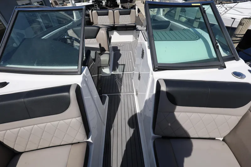 Slide: The Image of 2020 Bryant Calandra 23 boat interior with seating and windshield. - 24