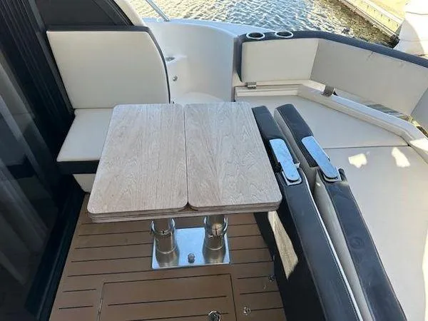 Slide: The Image of 2023 Bavaria R40 Coupe yacht deck with wooden table and seating area. - 10