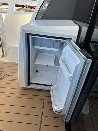 Slide: The Image of Open refrigerator on 2023 Bavaria R40 Coupe yacht deck. - 12