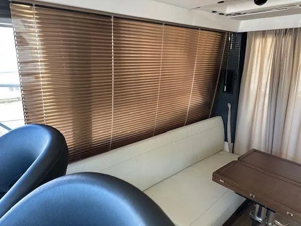 Slide: The Image of Interior of 2023 Bavaria R40 Coupe with white sofa, brown blinds, and wooden table. - 18