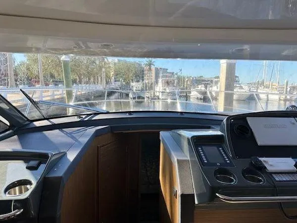 Slide: The Image of Interior view of 2023 Bavaria R40 Coupe yacht cockpit with marina in background. - 23